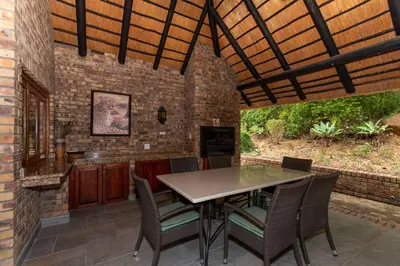 an outdoor dining area with a table and chairs at Kruger Park Lodge Unit No 441 with Private Pool in Hazyview