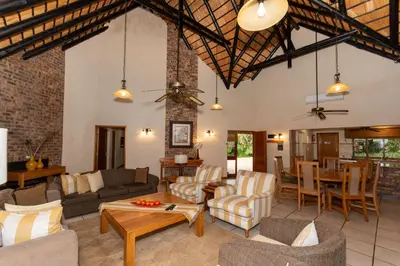 a living room with couches and a table at Kruger Park Lodge Unit No 441 with Private Pool in Hazyview