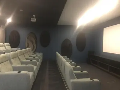 a cinema room with white chairs and a screen at The Blyde River Walk Estate in Pretoria