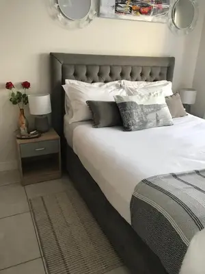 a bedroom with a large bed with white sheets and pillows at The Blyde River Walk Estate in Pretoria