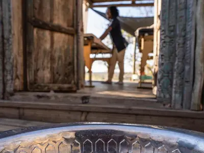 a woman standing in the doorway of a building at The Wild Blue Lodge SAFARI & SPA in Hoedspruit