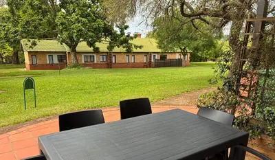 a table and chairs in front of a house at Thyme Inn on Greenway in White River