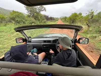 a group of people riding in a vehicle on a dirt road at Ngong Hill, Mabalingwe in Bela-Bela