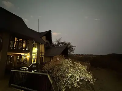a house with the sun setting behind it at Ngong Hill, Mabalingwe in Bela-Bela