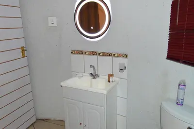 a bathroom with a sink and a mirror on the wall at Pan African Lodge & Safari in Marloth Park