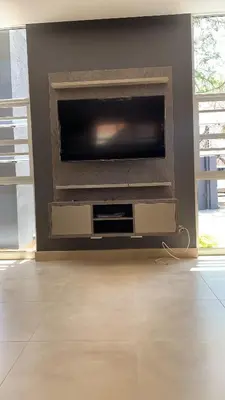 a living room with a flat screen tv on a wall at 77 On Burger in Polokwane