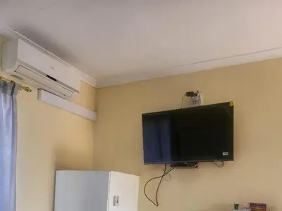 a flat screen tv on the wall of a room at Hadassa Lodge in Burgersfort
