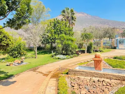 a park with a fountain in the middle of a road at Hadassa Lodge in Burgersfort