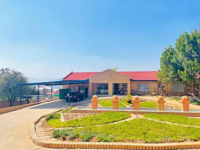 a building with a carport and a building at Hadassa Lodge in Burgersfort