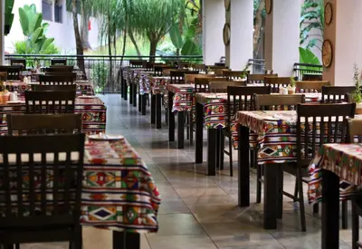 a row of tables and chairs in a restaurant at Umbhaba Eco Lodge in Hazyview