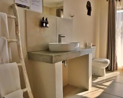 a bathroom with a sink and a toilet at Umbhaba Eco Lodge in Hazyview