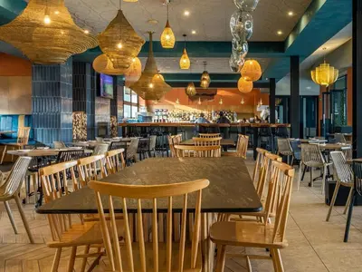 a restaurant with a table and chairs and a bar at The Blyde - Posh Living in Pretoria