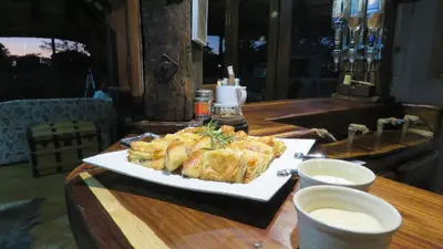 a plate of food on a wooden table at Berchtesgaden Game Ranch & Lifestyle Farm in Vaalwater