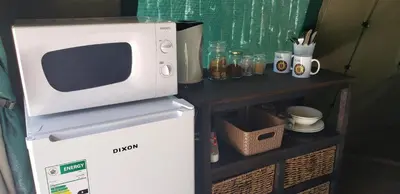 a microwave sitting on top of a refrigerator at Berchtesgaden Game Ranch & Lifestyle Farm in Vaalwater