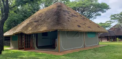 a small hut with a thatch roof at Berchtesgaden Game Ranch & Lifestyle Farm in Vaalwater