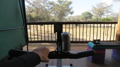 a person riding a train looking out a window at a fence at Berchtesgaden Game Ranch & Lifestyle Farm in Vaalwater