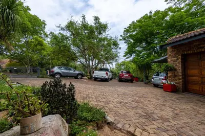 a parking lot with cars parked next to a house at Rozelee Rest 1 in Nelspruit