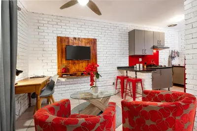 a kitchen with red chairs and a table in a room at Rozelee Rest 1 in Nelspruit