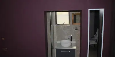 a bathroom with a white sink and a mirror at Thavhani boutique hotel in Thohoyandou