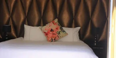 a bed with a pillow on top of it at Thavhani boutique hotel in Thohoyandou