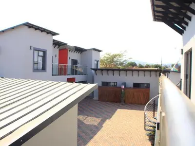 arial view of a house with a balcony and a yard at Thavhani boutique hotel in Thohoyandou