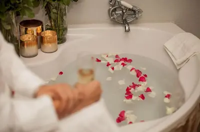 a bathroom sink with flowers on the seat of a toilet at Kilima Private Game Reserve & Spa in Gravelotte