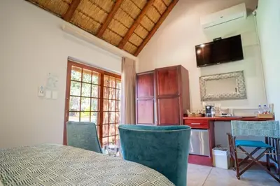 a kitchen with a table and chairs in a room at Kilima Private Game Reserve & Spa in Gravelotte
