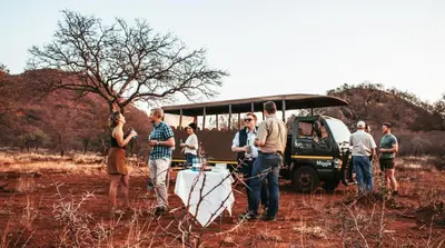 a group of people standing in front of a bus at Kilima Private Game Reserve & Spa in Gravelotte