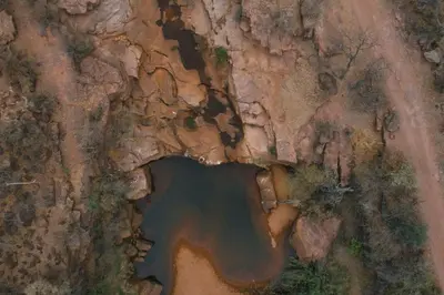 an aerial view of a lake on a rock cliff at Buccara Waterberg - Molapo in Lephalale
