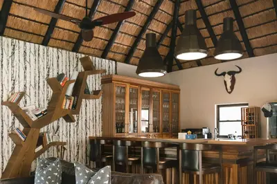 a bar in a restaurant with a skull on the wall at Buccara Waterberg - Molapo in Lephalale