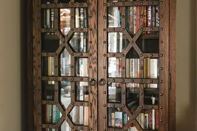 a wooden book case filled with books at Buccara Waterberg - Molapo in Lephalale