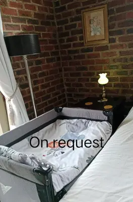 an on request sign on a bed in a room at 712@Rest in Dullstroom