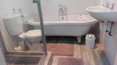a bathroom with a tub and a toilet and a sink at 712@Rest in Dullstroom