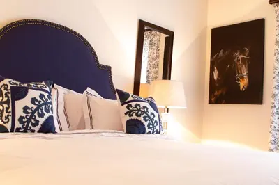 a bedroom with a bed with a horse picture on the wall at The Stables, Beaulieu Kyalami in Midrand