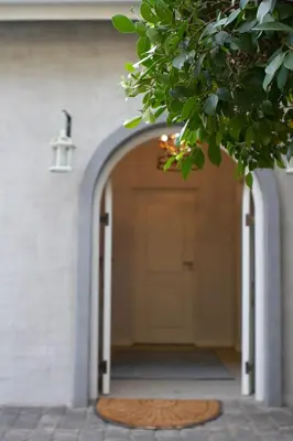 a door to a house with a mat in front at The Stables, Beaulieu Kyalami in Midrand