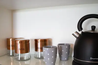 a group of coffee cups and a tea kettle on a counter at The Stables, Beaulieu Kyalami in Midrand