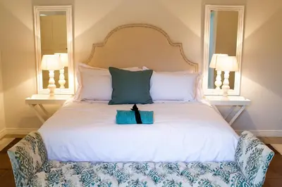 a bed with two mirrors and a box on it at The Stables, Beaulieu Kyalami in Midrand