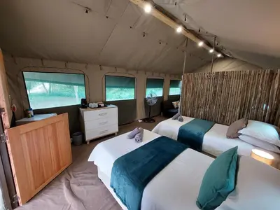 a bedroom with two beds in a tent at Rockview Lodge in Nelspruit