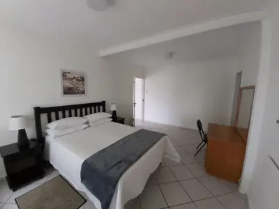 a bedroom with a large white bed in a room at Rockview Lodge in Nelspruit