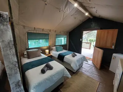 a bedroom with two beds in a tent at Rockview Lodge in Nelspruit