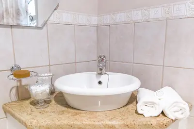 a bathroom with a white sink on a counter at Stans &co in Bethal