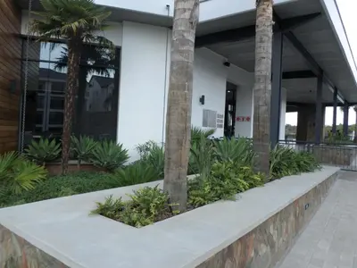 a building with palm trees in front of it at The Blyde Crystal Lagoon Cologne3 in Greenview