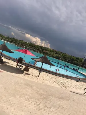 a group of people in the water at the beach at The Blyde Crystal Lagoon Cologne3 in Greenview