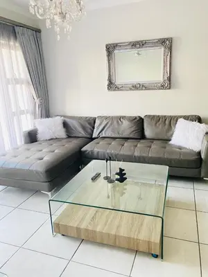 a living room with a couch and a glass coffee table at The Blyde Crystal Lagoon Cologne3 in Greenview