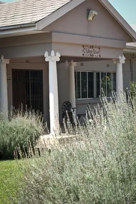 a house with a sign on the front of it at Olden Rose Place in Lephalale