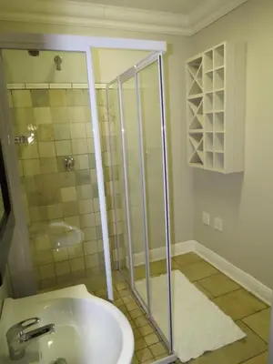 a bathroom with a shower and a sink at Olden Rose Place in Lephalale