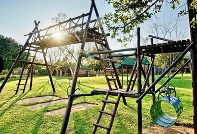 a wooden swing set in a park at Greenway Woods Chalet in White River