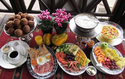 a table topped with plates of breakfast foods and drinks at The Woodsman Bed and Breakfast in Sabie