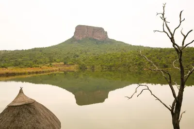 a view of a lake with a mountain in the background at Entabeni Mountain Lodges in Golders Green