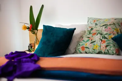 a close up of a persons leg on a couch with pillows at Mister C in Hartbeespoort